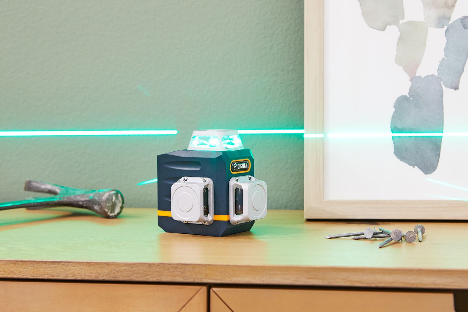 Cigman 3x360° Green Laser Level displayed shining a green laser on a wooden surface