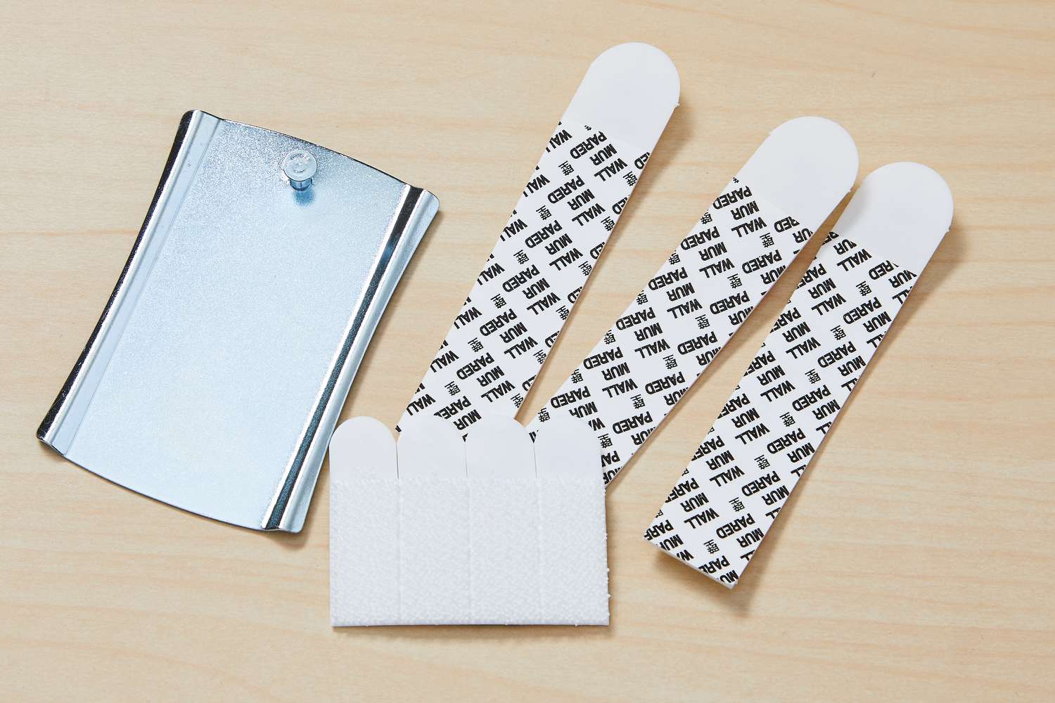 Overhead view of adhesive hooks for hanging things on a cinder block wall