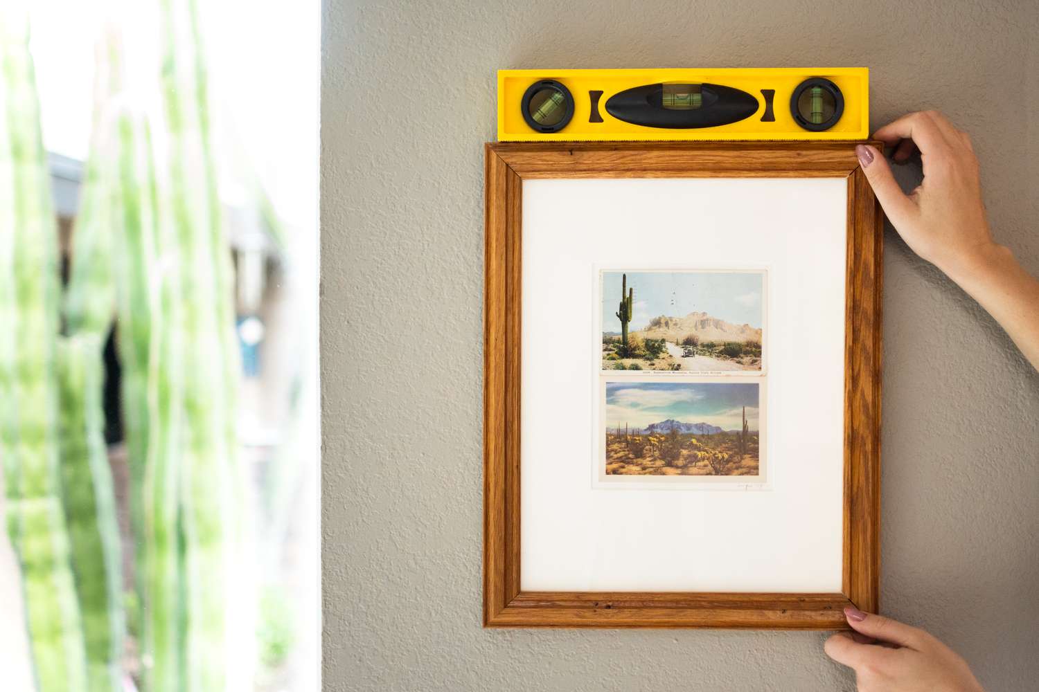 Picture frame placed on wall with yellow level on top