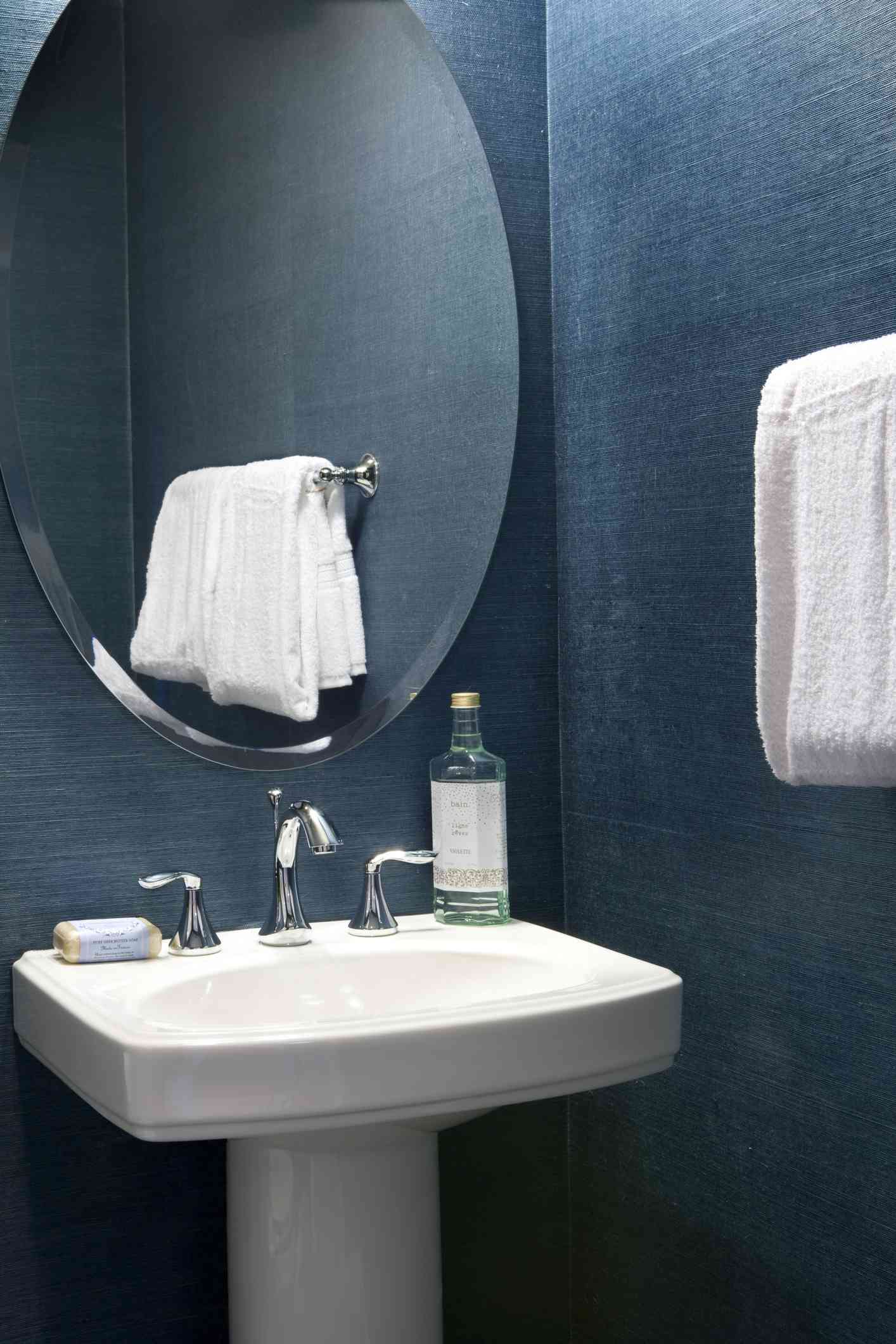 Dark navy blue bathroom with artificial lighting