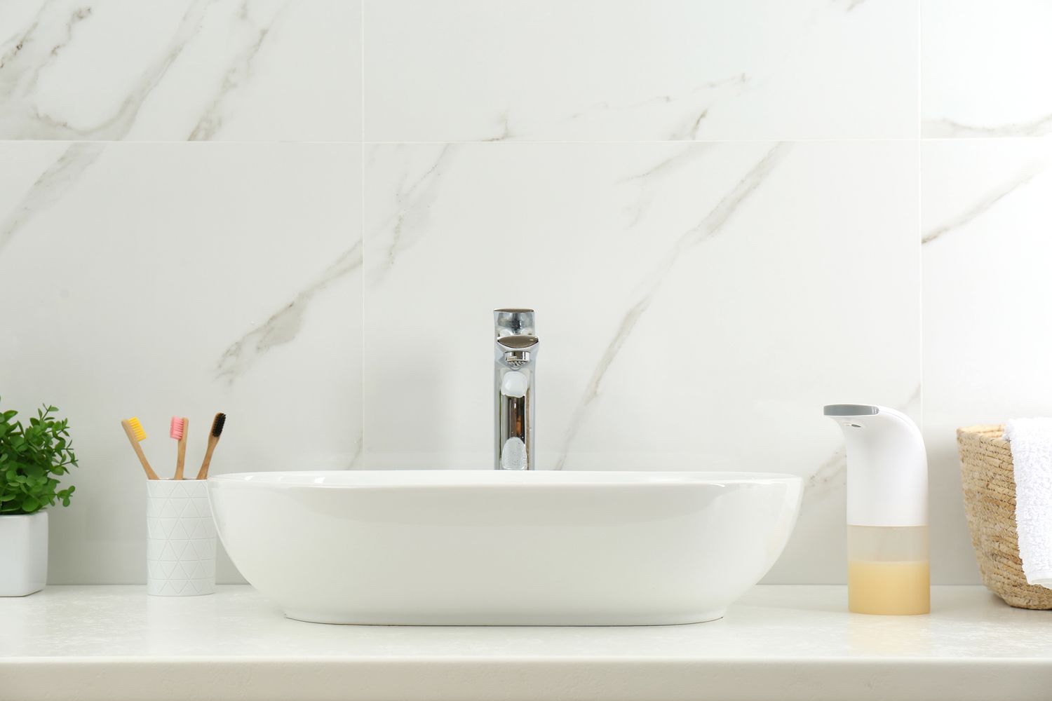 Touchless faucet over white sink basin