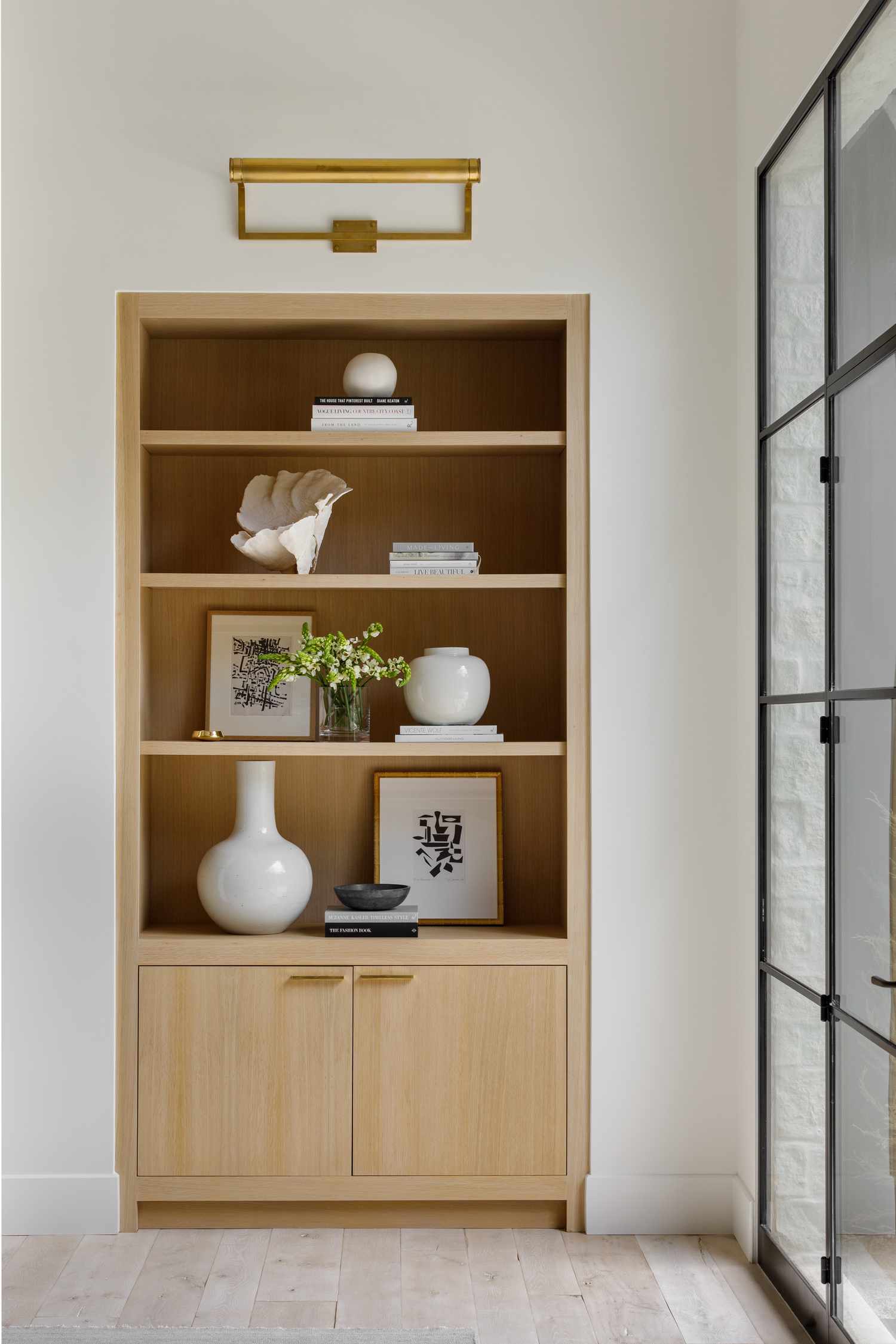 vase of flowers on bookshelf