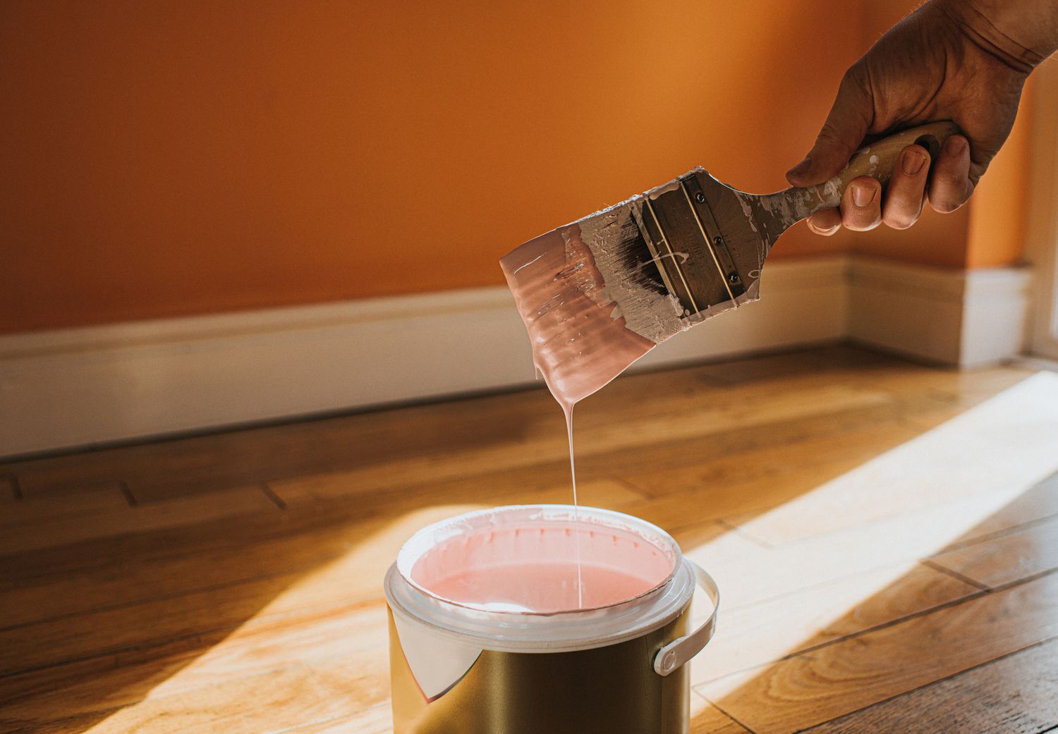 person painting walls in home