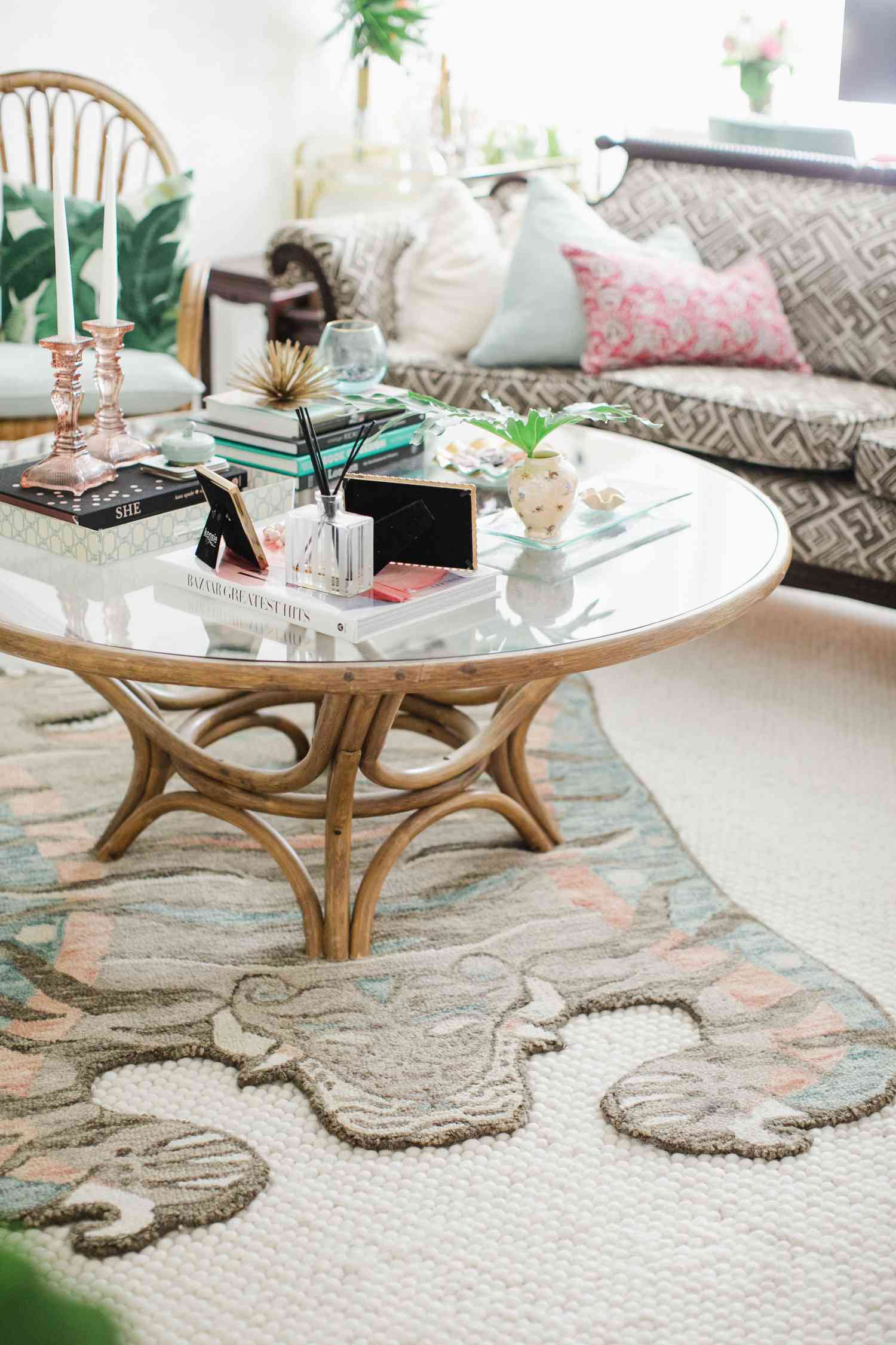 wood and glass table with patterned textiles