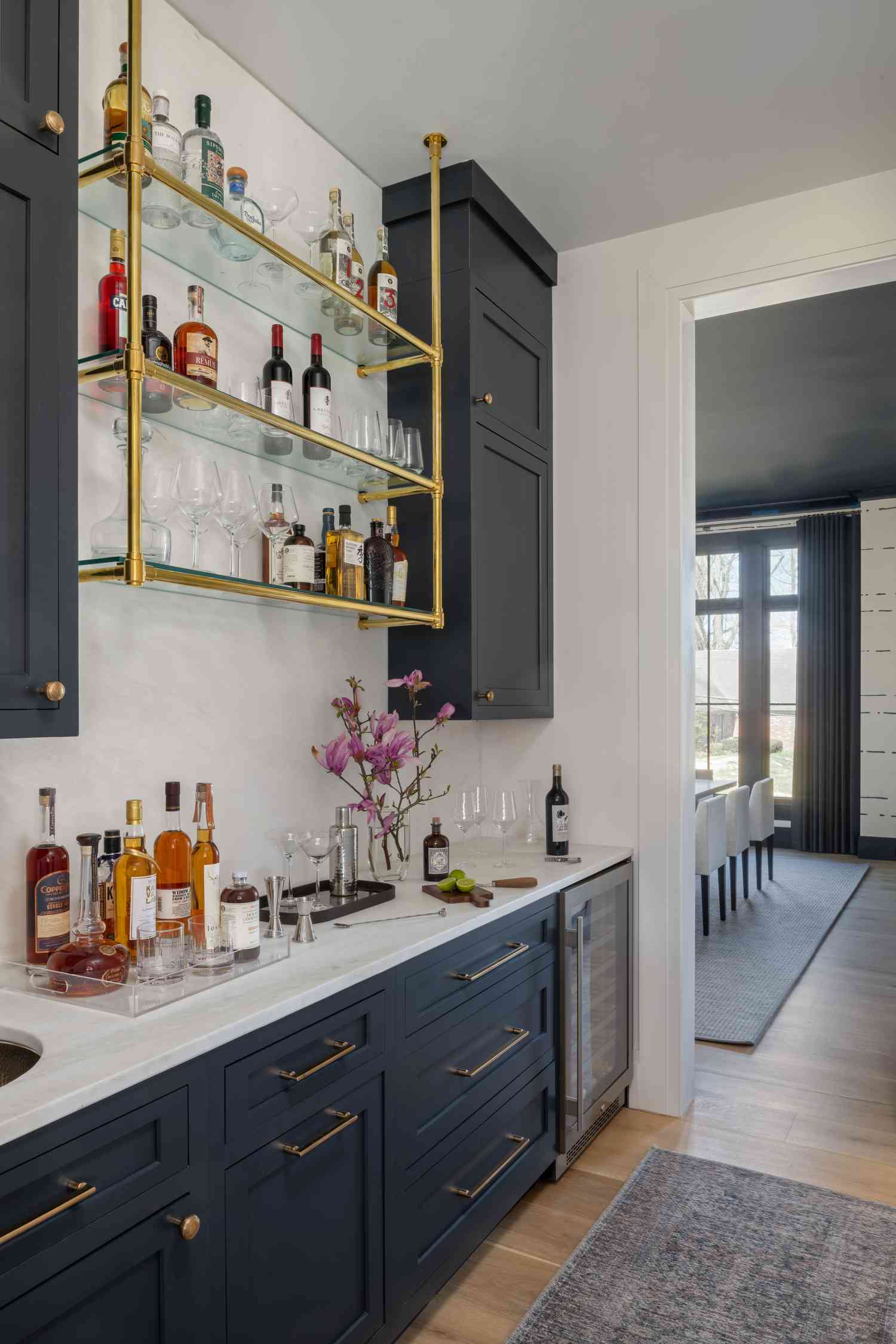 Walk-in pantry with bar and blue shaker cabinets.