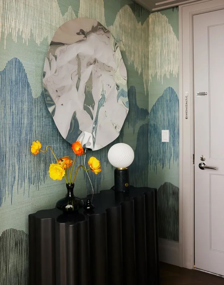 Small hallway/entryway with blue and green wallpaper.