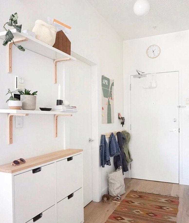 mudroom with clock above door
